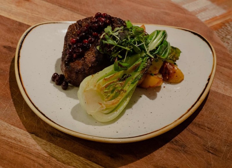 A plated main course with greens